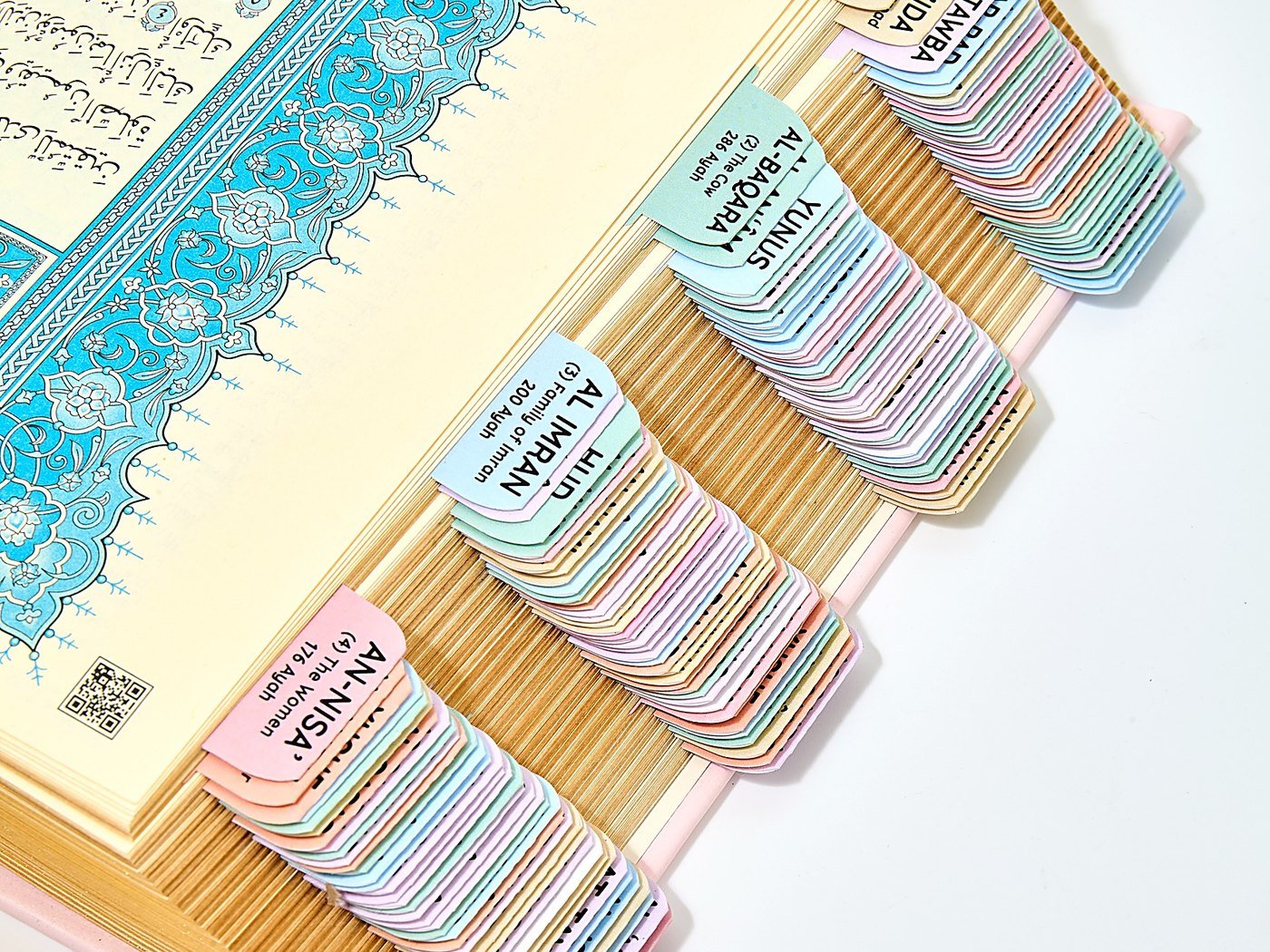Pastel Quran tabs applied on an ornate Mushaf